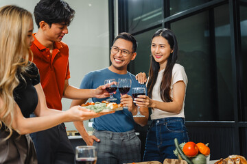 Asian office colleagues and friends enjoy a daytime BBQ with pizza and beer, celebrating Halloween and cheering for their favorite soccer team, creating a lively atmosphere filled with joy.