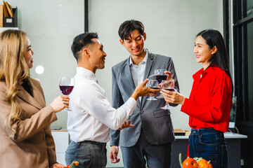 Asian office colleagues and friends enjoy a daytime BBQ with pizza and beer, celebrating Halloween and cheering for their favorite soccer team, creating a lively atmosphere filled with joy.