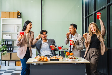 Asian office colleagues and friends enjoy a daytime BBQ with pizza and beer, celebrating Halloween and cheering for their favorite soccer team, creating a lively atmosphere filled with joy.