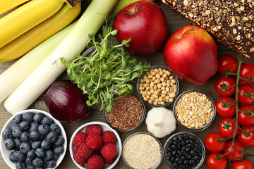 Different fresh products on wooden table, flat lay. Source of prebiotics