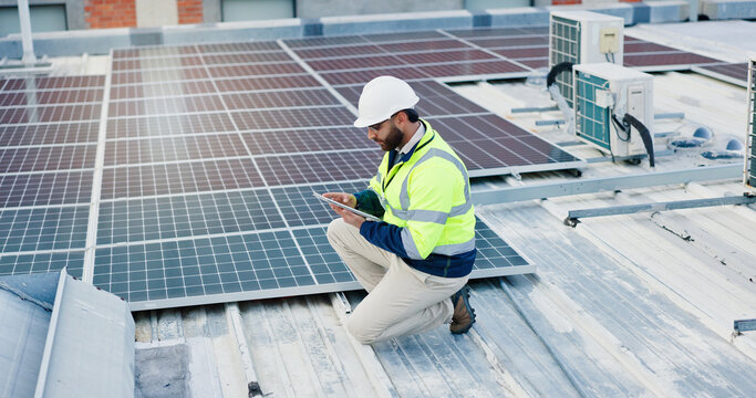 Technician, man and tablet for solar panels, energy saving and electricity or heating of eco friendly grid on rooftop. Engineering, digital technology and photovoltaic inspection for installation