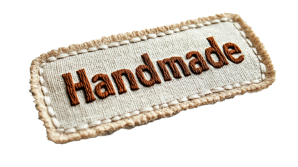 A stitched fabric label with "Handmade" in embroidered letters, background isolation, full depth of field
