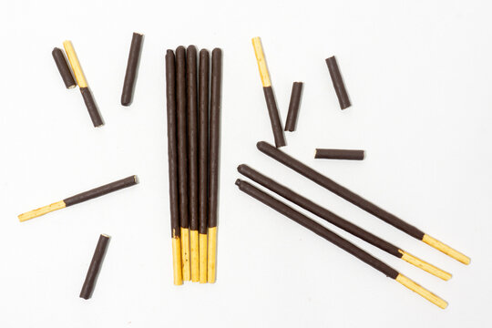 Chocolate covered sticks isolated on white background