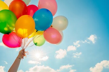 Colorful Balloons Floating in the Sky with Sunlight and Blue Skies, Evoking Joyful Celebrations and Festive Moments