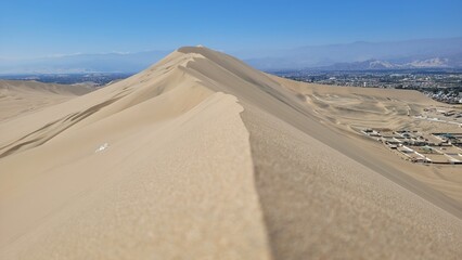 Sand dunes desert city Peru