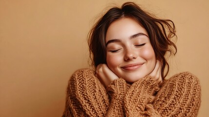 Happy smiling woman with closed eyes hugging herself wearing comfortable brown knitted sweater isolated on beige background Winter concept : Generative AI