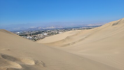 Sand dunes desert city Peru