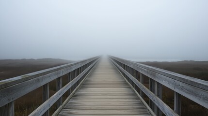 Fototapeta premium A foggy, misty day with a wooden bridge in the distance. The bridge is long and narrow, and the fog is thick and heavy