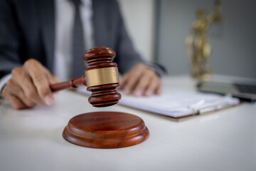 Close up of Judge gavel with Justice lawyers, Business senior man in suit or lawyer working on a documents. Legal law, advice and justice concept.
