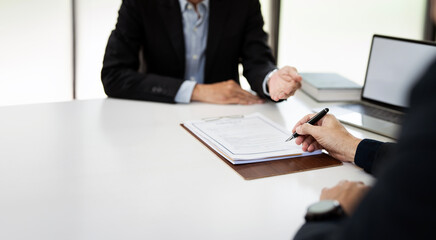 Businessman with lawyer discussing law firm business plan - signing a contract