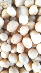 Texture of Potato Pile (Solanum tuberosum). Randomly stacked vegetables sold in Traditional Market. Textured Details. Fresh food ingredients. Wallpaper Backgrounds Photography Concepts