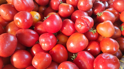 Texture of Pile of Red Tomatoes (Lycopersicon esculentum Mill). Randomly stacked vegetables sold in Traditional Market. Textured Details. Fresh food ingredients. Wallpaper Backgrounds Photography 