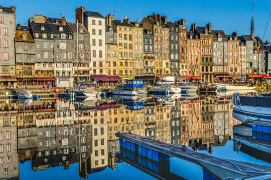 Colorful morning waterfront reflections, Inner Harbor, Honfleur, France. Honfleur is famous for its reflections, which inspired Monet