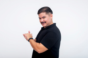Side view of a man revealing his role in a devious plan staring at the camera while rubbing his hands. against a white background.