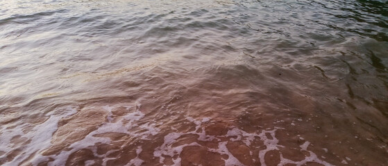 Nature background image of foamy wave on sand