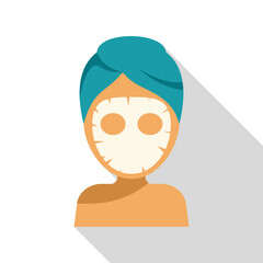 Woman is relaxing with a cosmetic face mask and a towel on her head