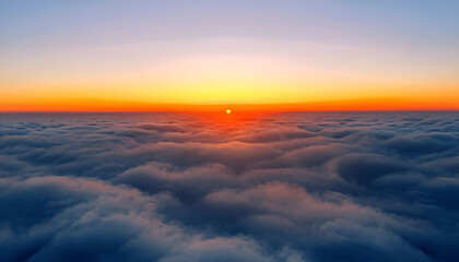 Obraz premium A breathtaking aerial view of a sunrise above a sea of clouds, with the sun casting a golden glow across the sky.