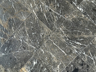 Natural and luxurious dark grey marble cut in square diagonal pattern with white veinings, dark natural marble from Italy. Seamless texture.