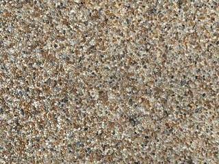 Cemented small random cut rubbles and cobble stones in brown and beige earth colors into cemented precast mold. 