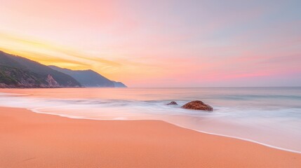 Obraz premium Tranquil Beach Sunset with Gentle Waves and Rocky Outcrop