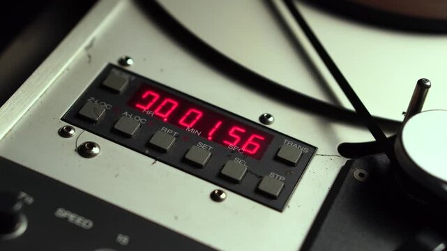 Time Counter and Rolling Reel to Reel Audio Tape With Analog Sound Recording, Close Up