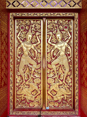 Close up of Thailand Buddhist temple engraving and mural art pattern on doors, carved in every details, mainly in red and gold colors. Grand luxurious religious feel. Seamless background texture. 