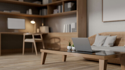 A laptop on a coffee table in a cozy contemporary living room, creates a warm atmosphere.