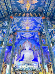 Buddha statue inside Blue Temple, Chiang Rai, Thailand. Decorated all in blue mural paints and...