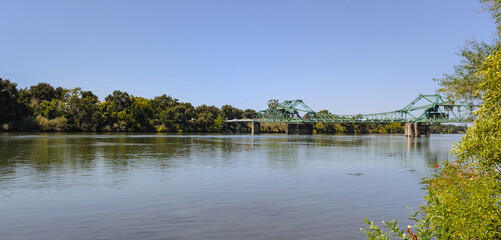 Panorama of a green drawbridge over sacramento river 