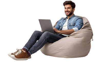 Young Man Sitting In A Bean Bag Chair Working On His Laptop And Smiling Isolated On Transparent Background.
