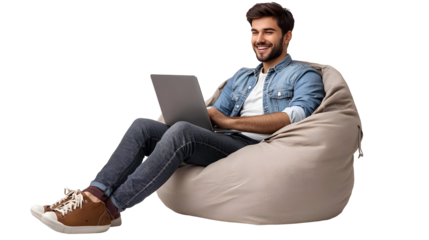 Young Man Sitting In A Bean Bag Chair Working On His Laptop And Smiling Isolated On Transparent Background.