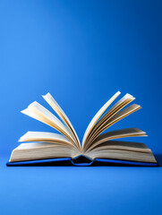 Naklejka premium Open book on blue background