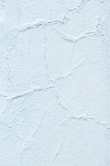 The beautifully textured light white wall features a unique cracked finish that enhances its charm