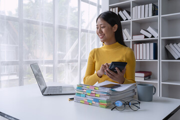 woman meticulously plans a finance audit, using a computer and calculator to review budget...