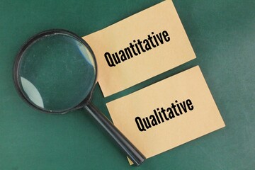 magnifying glass and paper with the words quantitative and qualitative