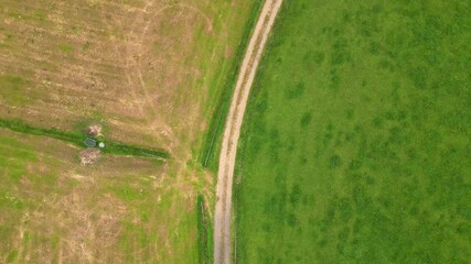 A stunning aerial view beautifully showcasing extensive lush green fields along with cultivated farmland areas