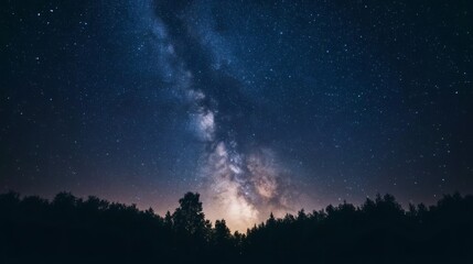 A dark forest silhouette against a backdrop of a vast, starry night sky with the Milky Way Galaxy visible.