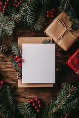 Festive holiday stationery card surrounded by fir and gift boxes