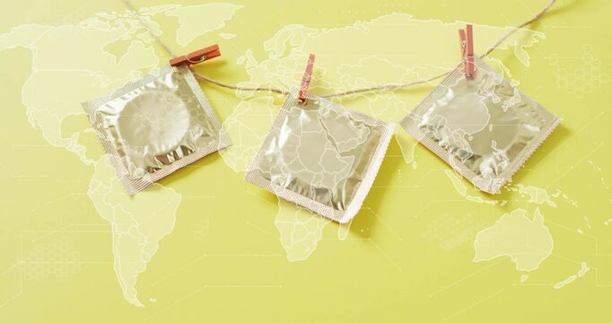 Condoms hanging on clothesline over world map animation