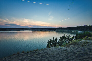 See im Abendrot - Sunset - Landscape - Beautiful Sunset scene over the lake and silhouette hills in the background - Sunrise over sea - Colorful - Reed - Clouds - Sky - Sundown - Sun	