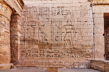 Famous wall relief of Ramesses III presenting captives of the Sea Peoples to Amun and Mut at the inner temple in Medinet Habu, the Mortuary temple of Ramesses III at Luxor,Egypt
