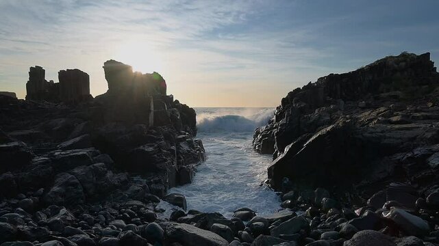 Waves of the Ocean crashing on to basalt rocks at Bombo Quarry NSW Sydney Australia