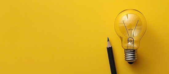 Creative concepts and inspiration for business featuring a lightbulb and pencil on a yellow background Motivation for success Think big ideas. Copy space image. Place for adding text and design