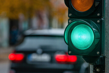 A city crossing with a semaphore. Green light in semaphore