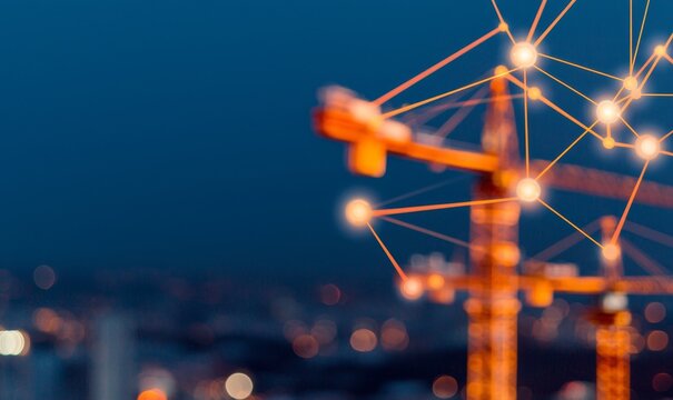 construction site at night with abstract digital network light lines and nodes connecting for modern building and industry concept.