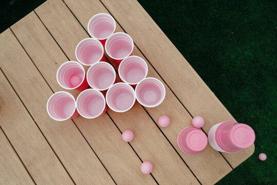 Beer pong setup with pink cups and balls