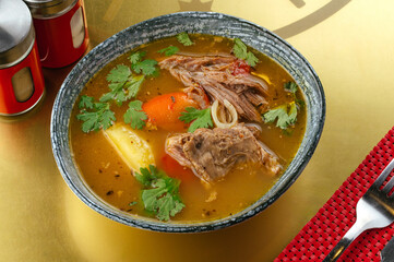 soup with meat and vegetables in a bowl