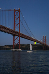 Beautiful view to 25 de April Bridge over Tejo River on early night.