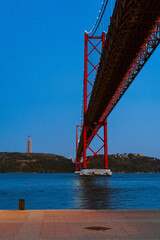 Beautiful view to 25 de April Bridge over Tejo River on early night.