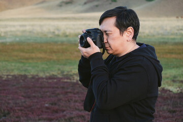 Photographer capturing nature with a camera in a serene outdoor